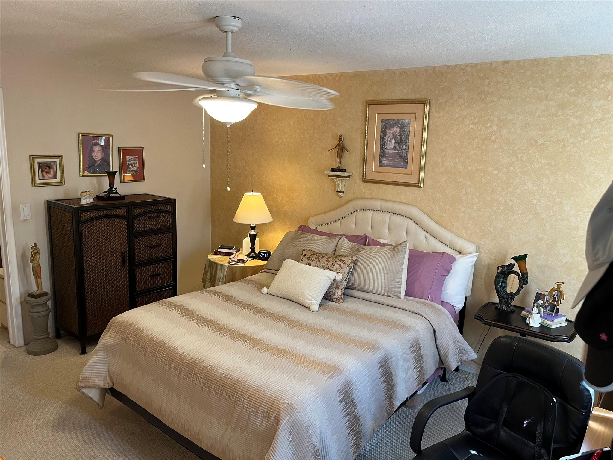 412 South Luna Court, Unit 2 Hollywood, FL 33021 - Photo 9 of 20 a bedroom with a bed and a chandelier