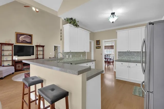 a kitchen with a refrigerator and a stove top oven