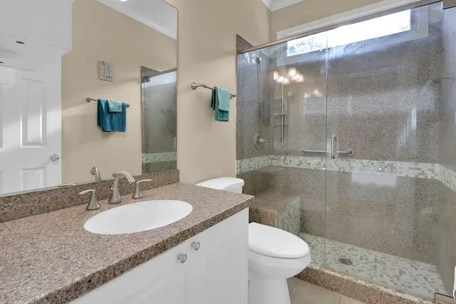a bathroom with a sink toilet and shower