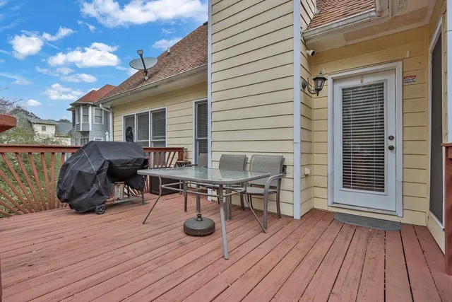 a view of a deck with table and chairs with wooden floor and fence