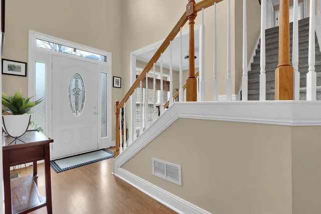 a view of staircase with furniture and a window