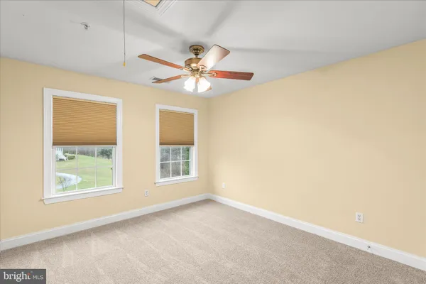 a view of a backyard with wooden fence