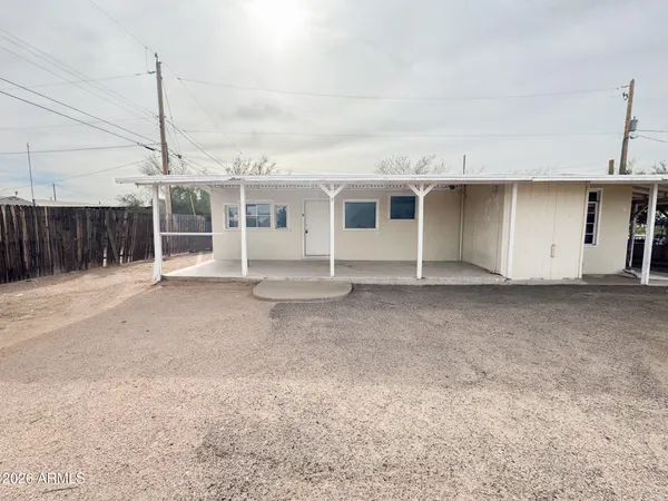 a view of a house with a backyard