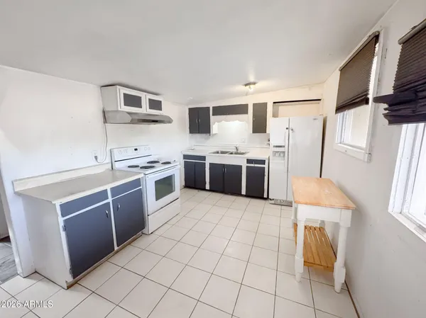 a kitchen with stainless steel appliances a stove a sink and a refrigerator