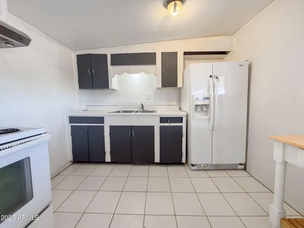 a kitchen with stainless steel appliances a sink stove and cabinets