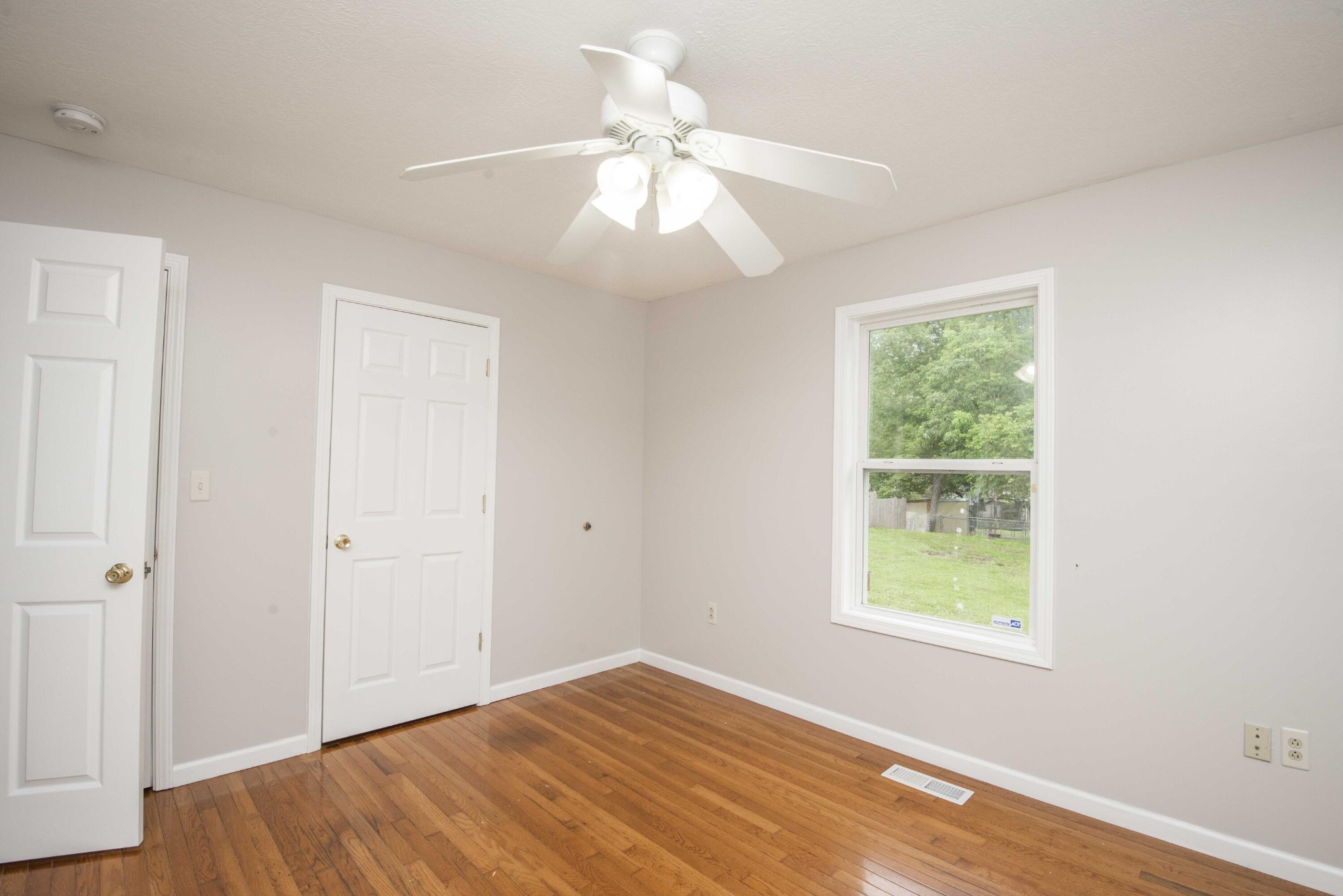 107 East Arrowwood Road Oak Ridge, TN 37830 - Photo 19 of 25 an empty room with wooden floor fan and windows
