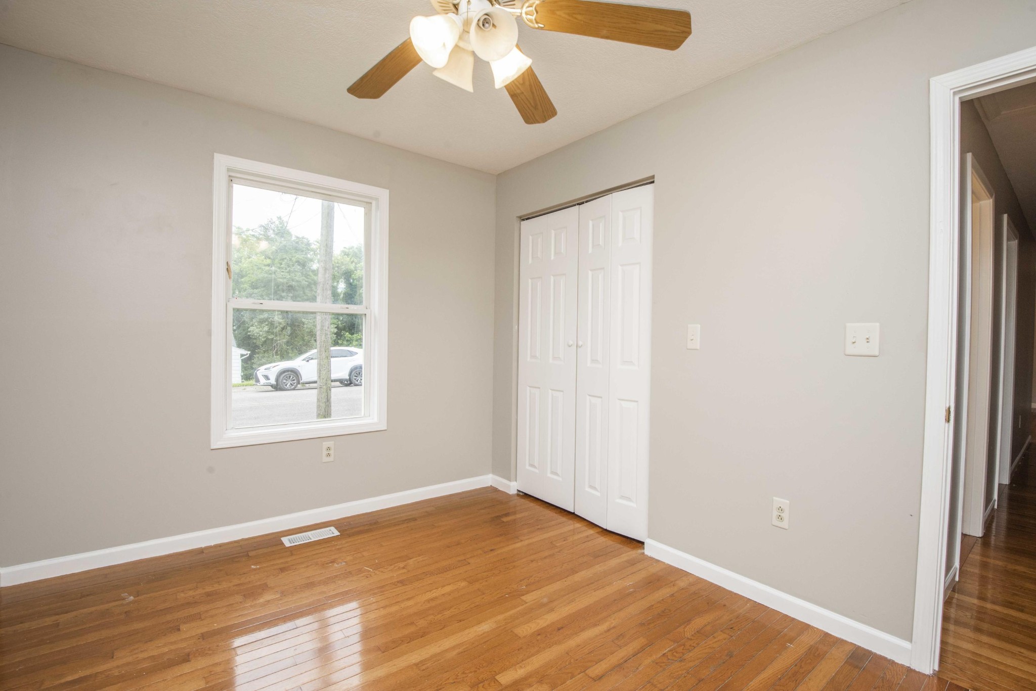 107 East Arrowwood Road Oak Ridge, TN 37830 - Photo 23 of 25 a view of an empty room with wooden floor and a window