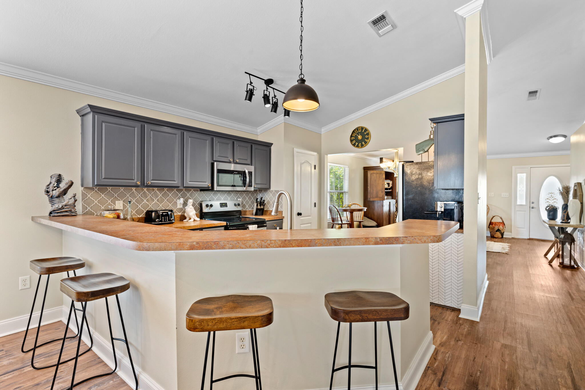 90 South Harborview Road Santa Rosa Beach, FL 32459 - Photo 12 of 33 a kitchen with stainless steel appliances granite countertop a refrigerator a sink dishwasher a dining table and chairs with wooden floor