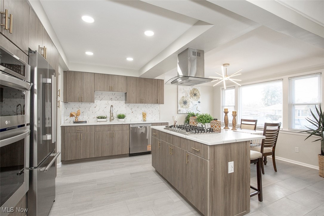 4631 Belfiore Road Cleveland, OH 44128 - Photo 9 of 28 Kitchen featuring a center island, appliances with stainless steel finishes, modern cabinets, island range hood, and recessed lighting