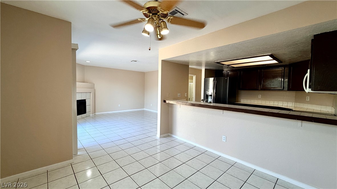 6250 West Flamingo Road, Unit 4 Las Vegas, NV 89103 - Photo 8 of 45 This inviting interior features an open-concept design, connecting the living area to the kitchen with a convenient breakfast bar.