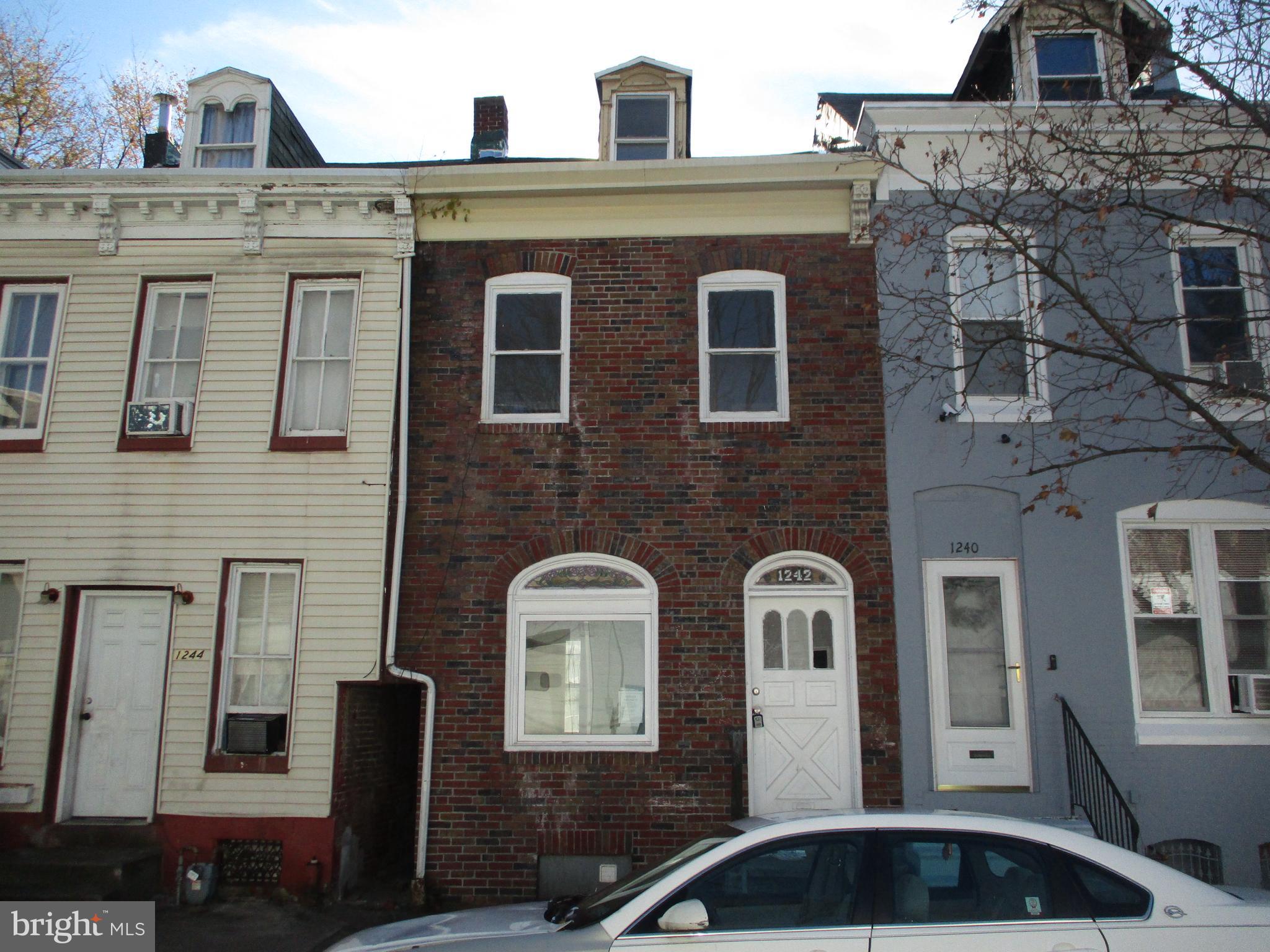 a front view of a house with many windows