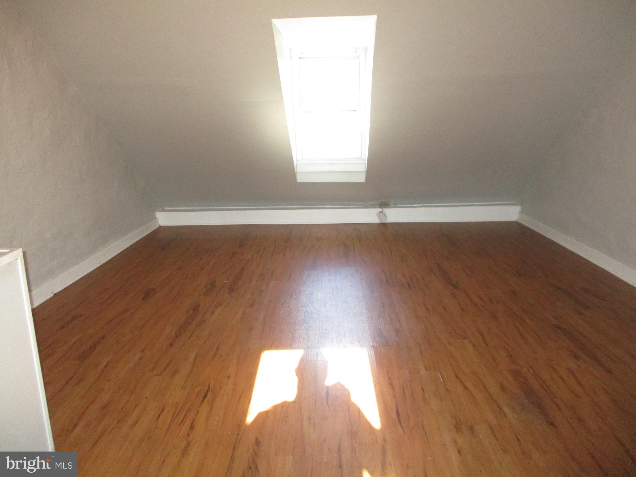 1242 Muhlenberg Street Reading, PA 19602 - Photo 13 of 18 a view of a room with wooden floors and window
