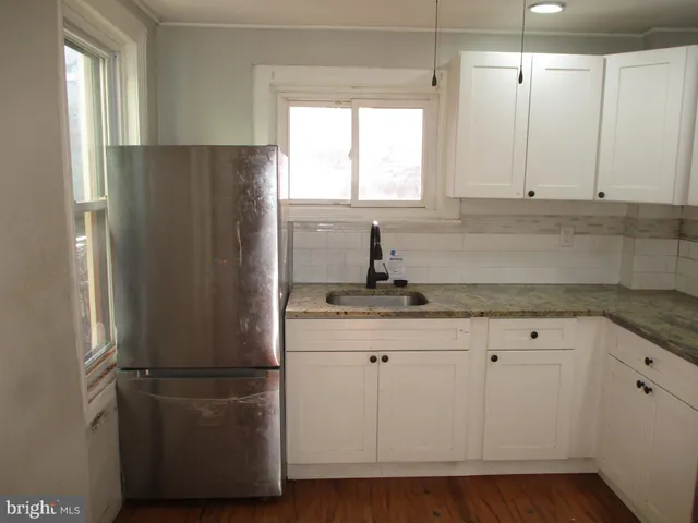 a kitchen with appliances a sink and a window