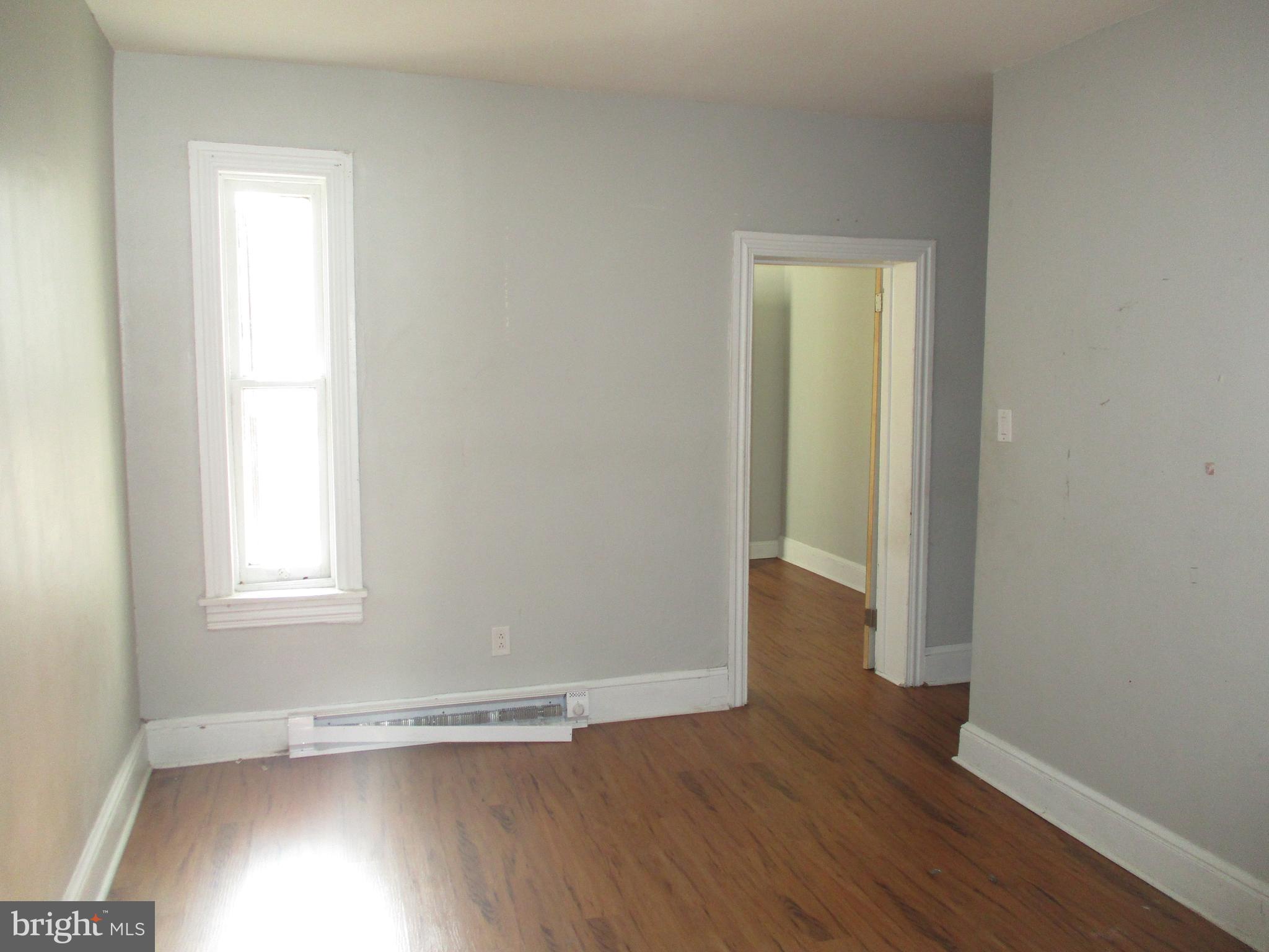 1242 Muhlenberg Street Reading, PA 19602 - Photo 10 of 18 an empty room with wooden floor and windows
