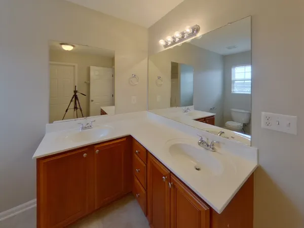 a bathroom with a sink vanity and mirror