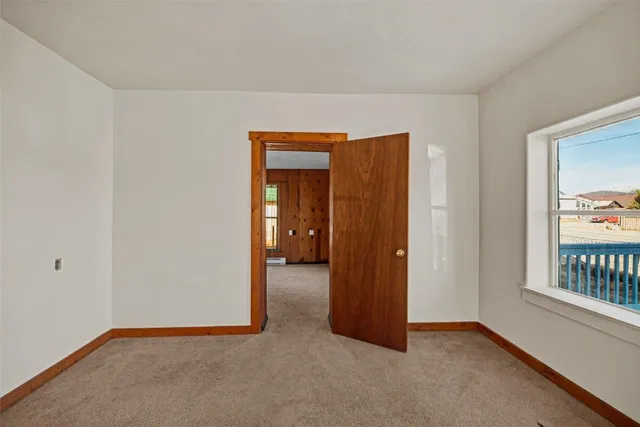 an empty room with windows and closet