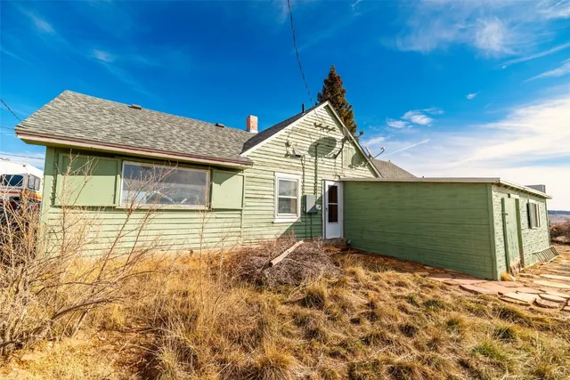 a view of a house with wooden fence