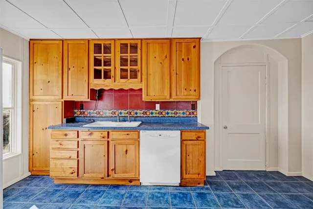 a kitchen with stainless steel appliances granite countertop wooden cabinets and a sink