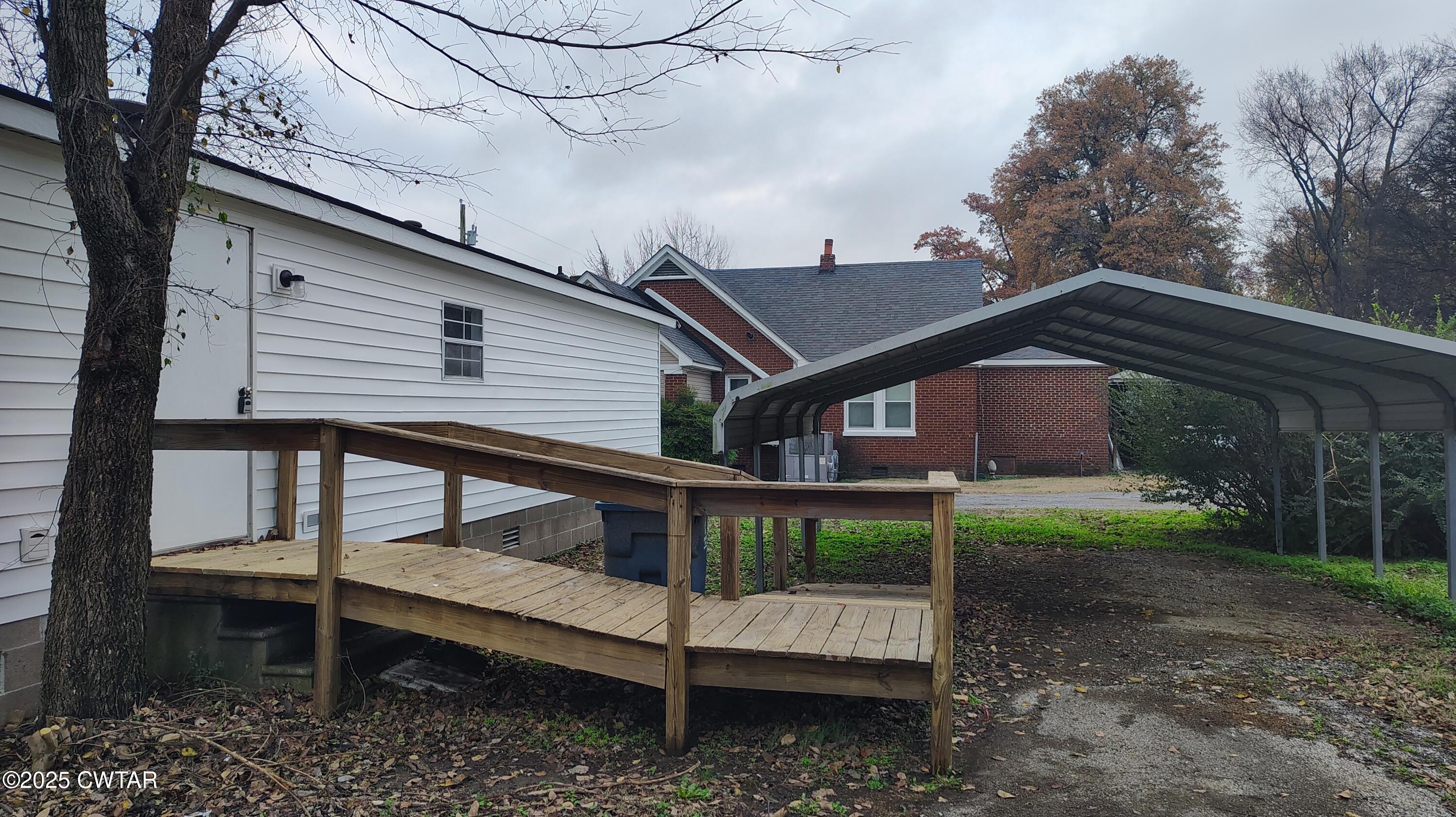 420 South Main Street Ridgely, TN 38080 - Photo 12 of 13 a small house with a bench in the deck
