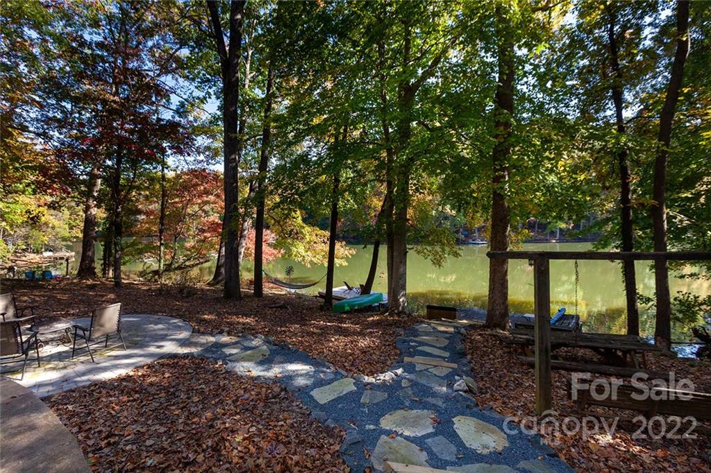 4301 Eagle Lake Drive Charlotte, NC 28217 - Photo 39 of 41 a backyard of a house with barbeque oven table and chairs