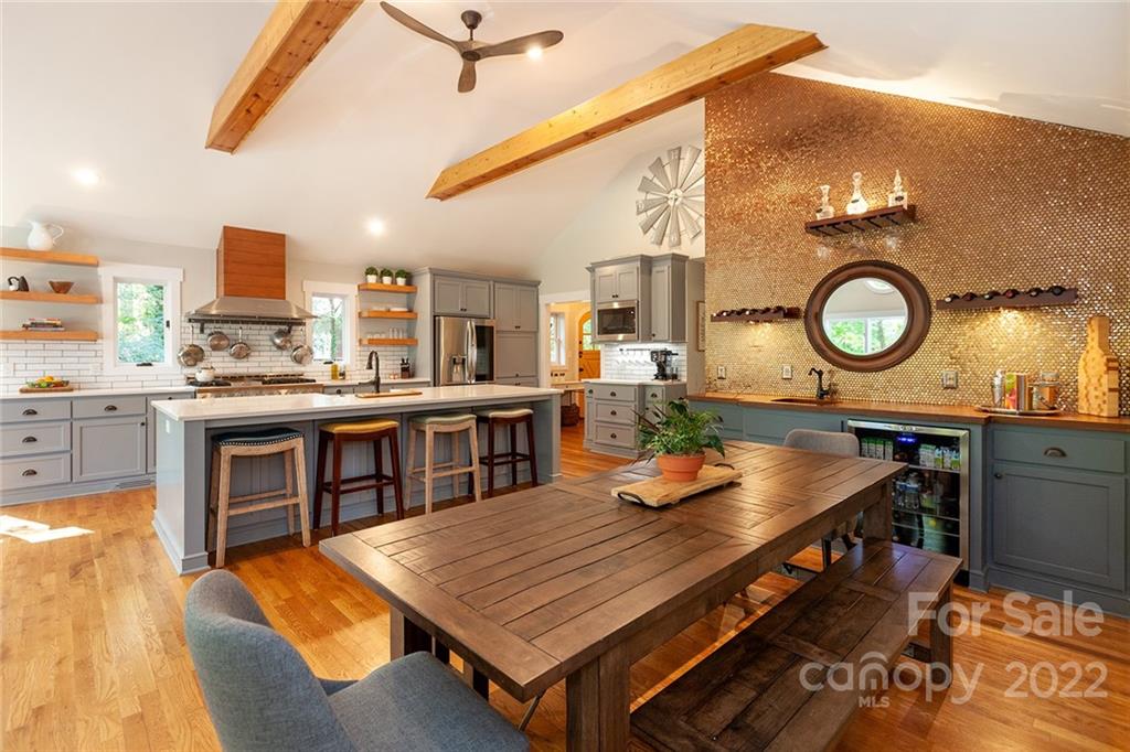 4301 Eagle Lake Drive Charlotte, NC 28217 - Photo 4 of 41 a kitchen with stainless steel appliances granite countertop a stove a sink dishwasher and white cabinets with wooden floor