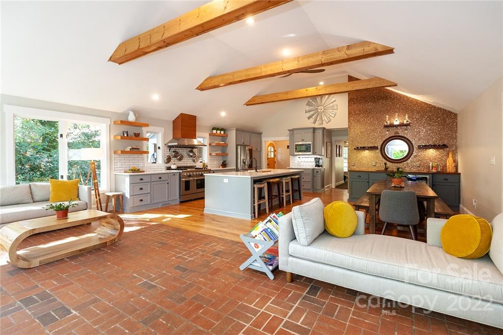 4301 Eagle Lake Drive Charlotte, NC 28217 - Photo 7 of 41 a living room with a couch and dining table with wooden floor
