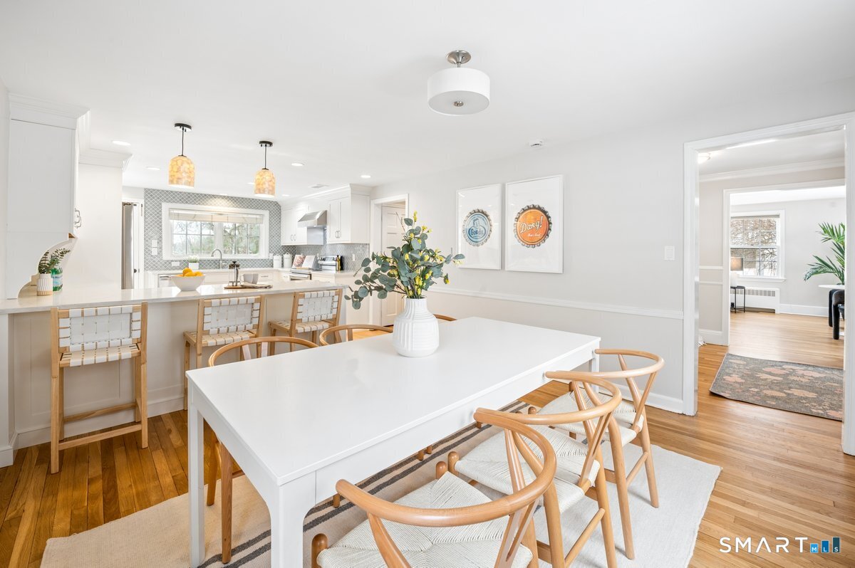 1091 Round Hill Road Fairfield, CT 06824 - Photo 14 of 28 a view of a dining room with furniture and a kitchen view