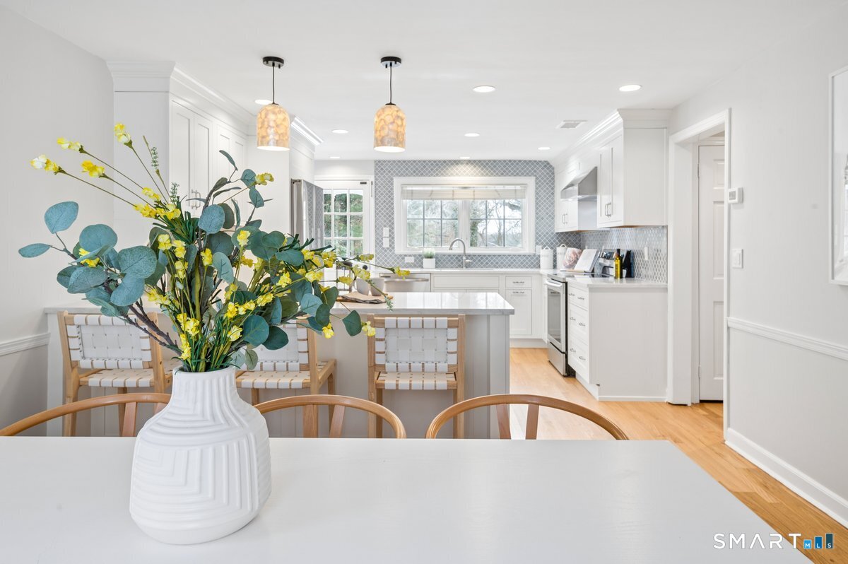 1091 Round Hill Road Fairfield, CT 06824 - Photo 15 of 28 a view of living room kitchen with furniture and a potted plant