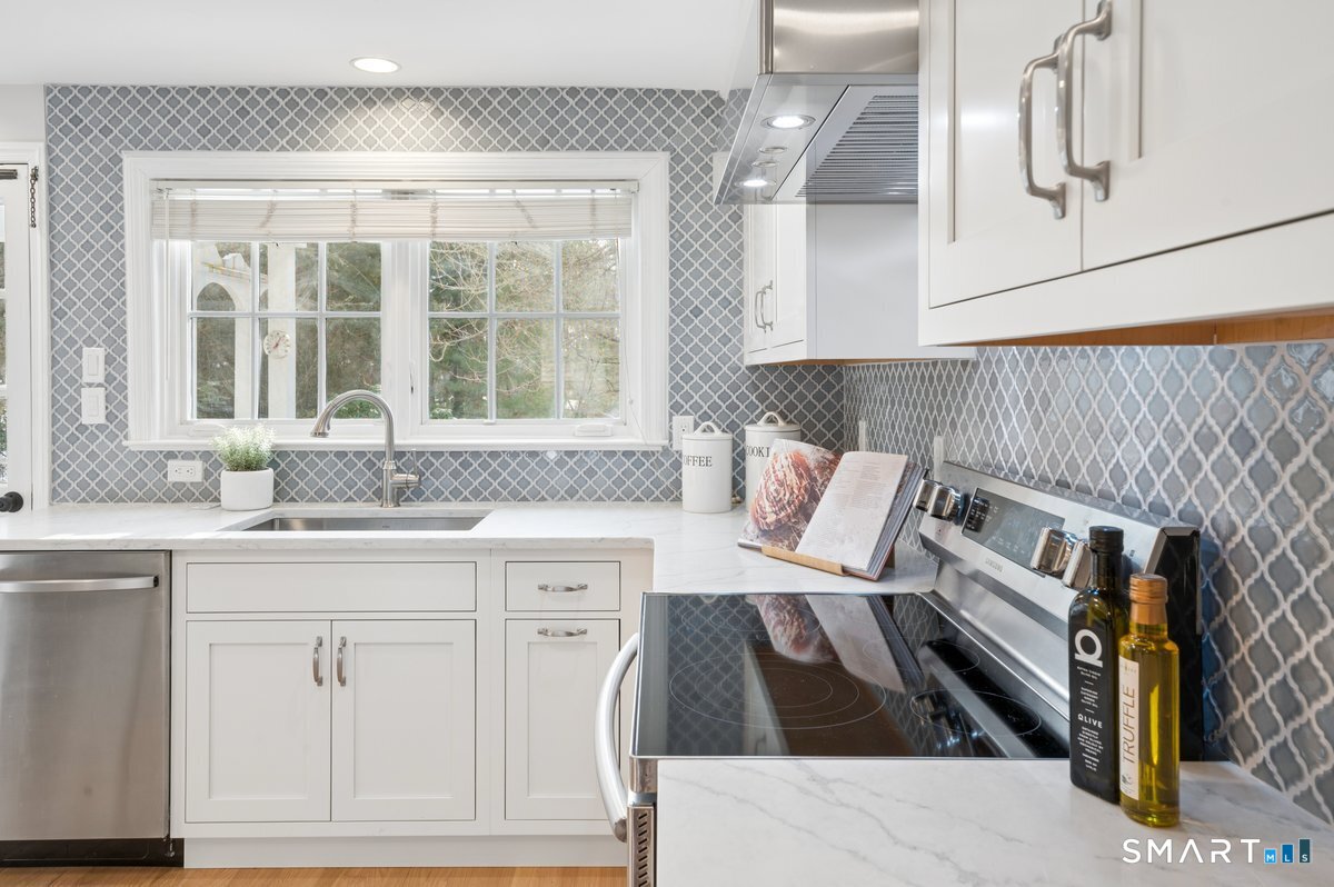 1091 Round Hill Road Fairfield, CT 06824 - Photo 16 of 28 a kitchen with a sink and cabinets