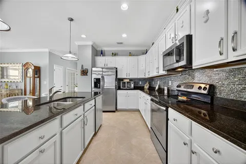 a kitchen with stainless steel appliances granite countertop a sink and cabinets
