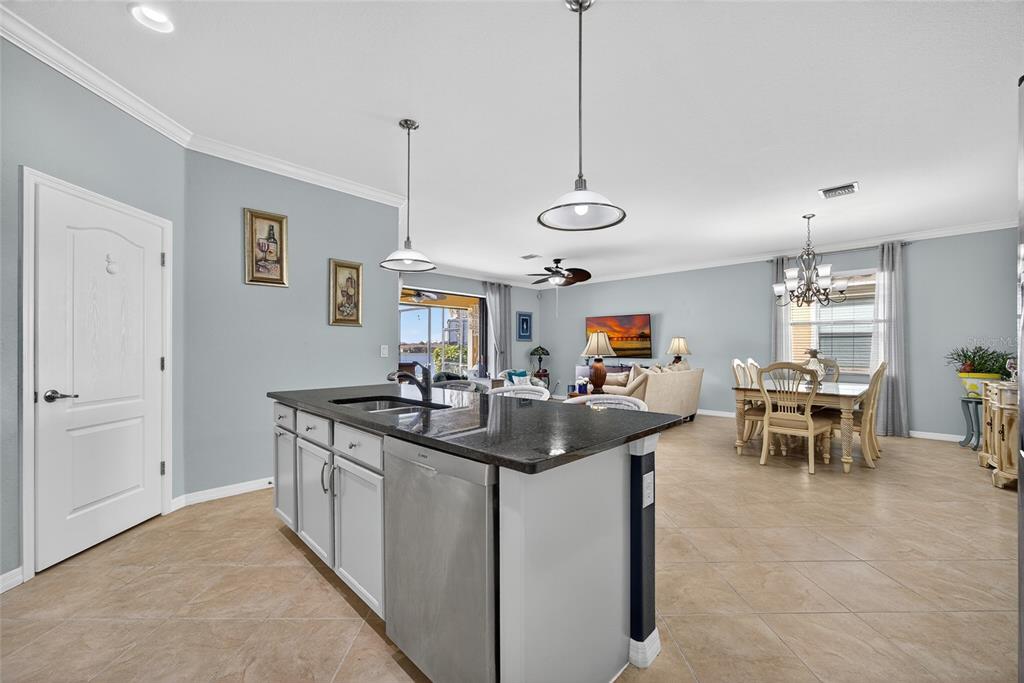 2877 Via Piazza Loop Fort Myers, FL 33905 - Photo 14 of 39 a kitchen with stainless steel appliances granite countertop a sink and a table