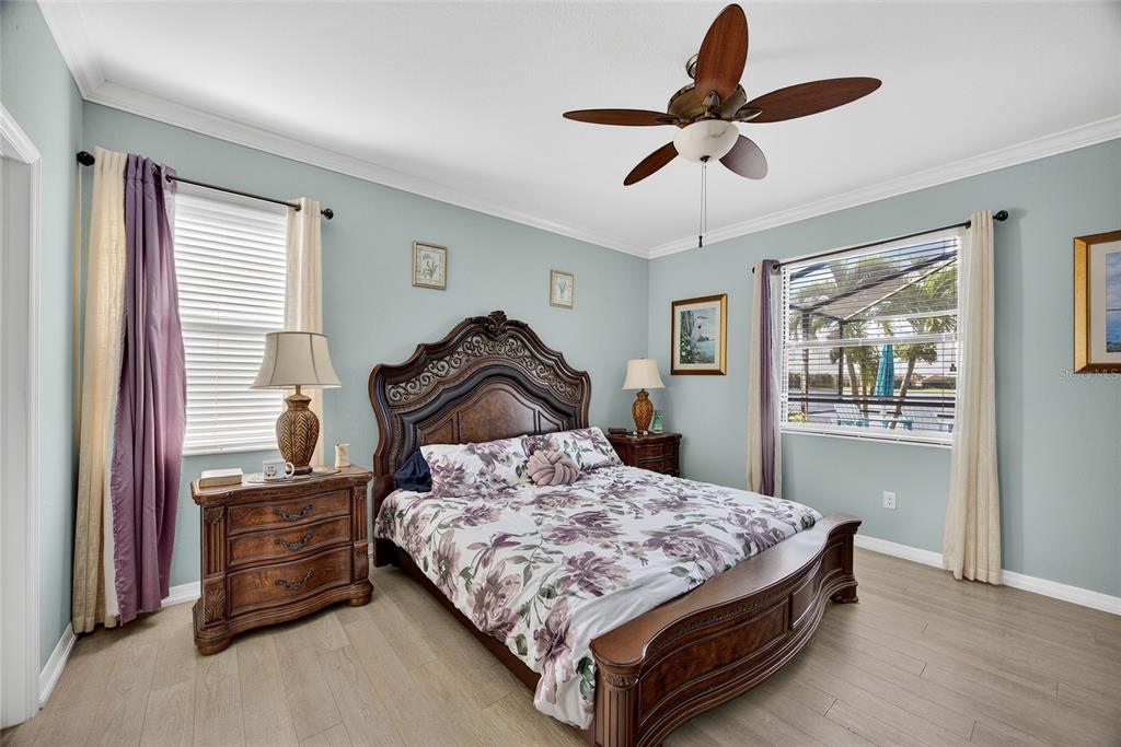 2877 Via Piazza Loop Fort Myers, FL 33905 - Photo 16 of 39 a bedroom with a bed and a chandelier