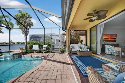 a living room with patio furniture and a potted plant