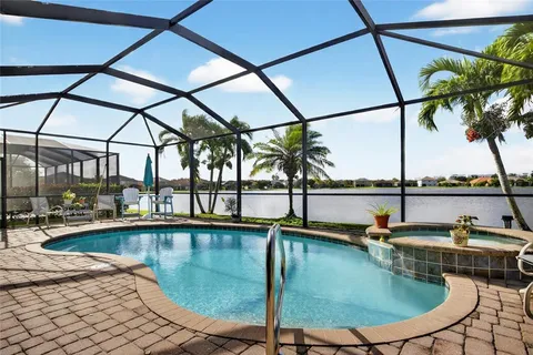 a view of a swimming pool with outdoor seating