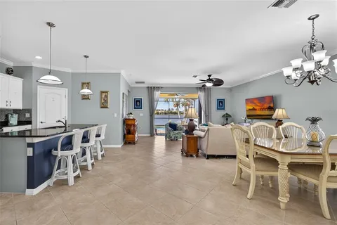 a view of a dining room with furniture and chandelier