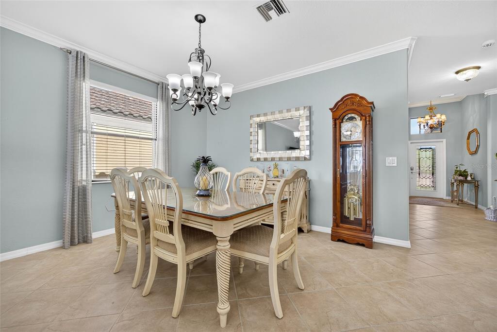 2877 Via Piazza Loop Fort Myers, FL 33905 - Photo 8 of 39 a view of a dining room with furniture and chandelier