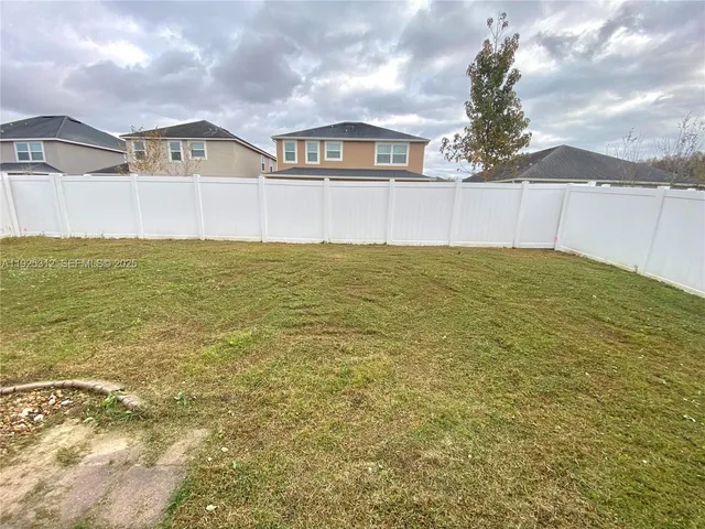 a view of a big room with yard and front view of a house