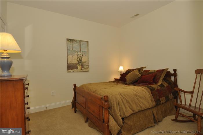 115 Fox Trail Terrace Gaithersburg, MD 20878 - Photo 11 of 22 a bedroom with a bed and painting on the wall