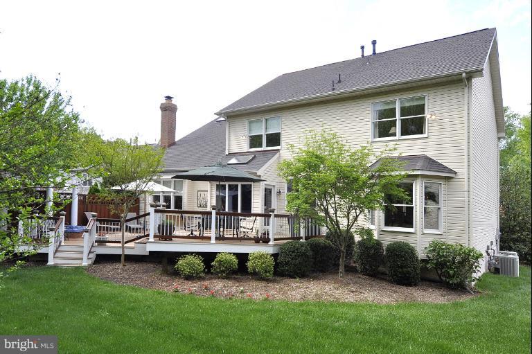 115 Fox Trail Terrace Gaithersburg, MD 20878 - Photo 12 of 22 a front view of a house with a garden and plants