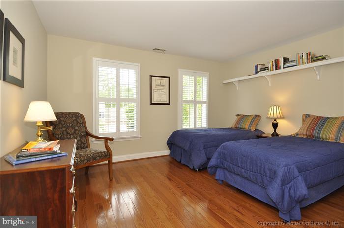 115 Fox Trail Terrace Gaithersburg, MD 20878 - Photo 8 of 22 a bedroom with a bed and wooden floor