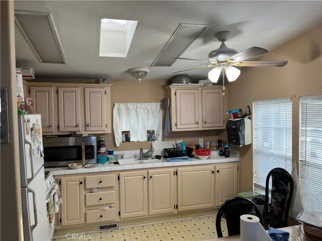 a kitchen with cabinets appliances and a window