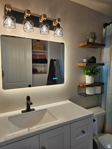 705 North 700 East Payson, UT 84651 - Photo 15 of 30 Bathroom with a textured wall, vanity, and a shower with curtain