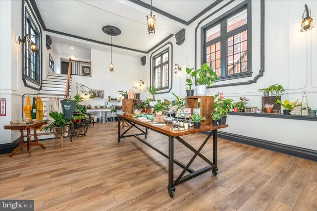 a kitchen with stainless steel appliances kitchen island granite countertop a refrigerator a stove a microwave oven a sink with island and chairs