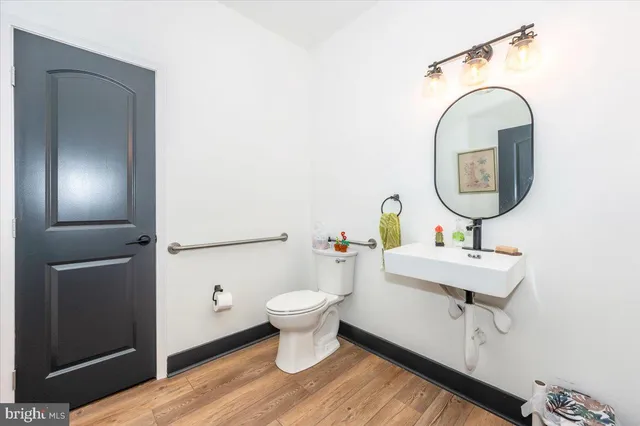 a bath room with a table chair and a chandelier