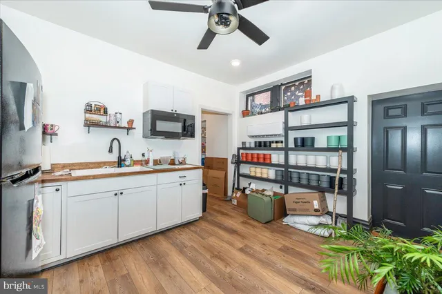 a living room with furniture a large window and a chandelier