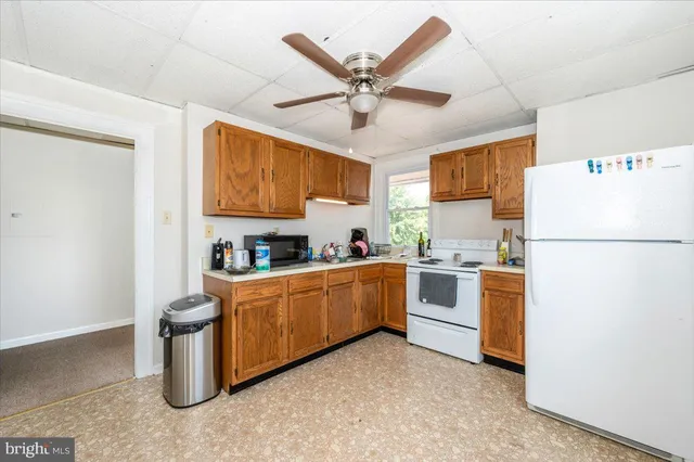 a kitchen with stainless steel appliances granite countertop a sink dishwasher stove and cabinets with wooden floor