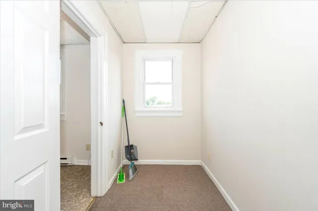 a view of parking with cars parked in front of it