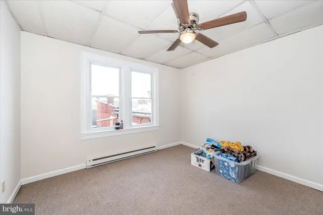 a front view of a building with outdoor seating