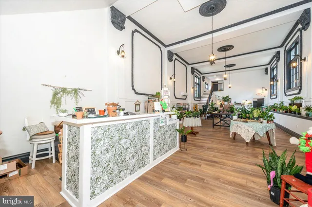 a living room with furniture or wooden floor and a floor to ceiling window
