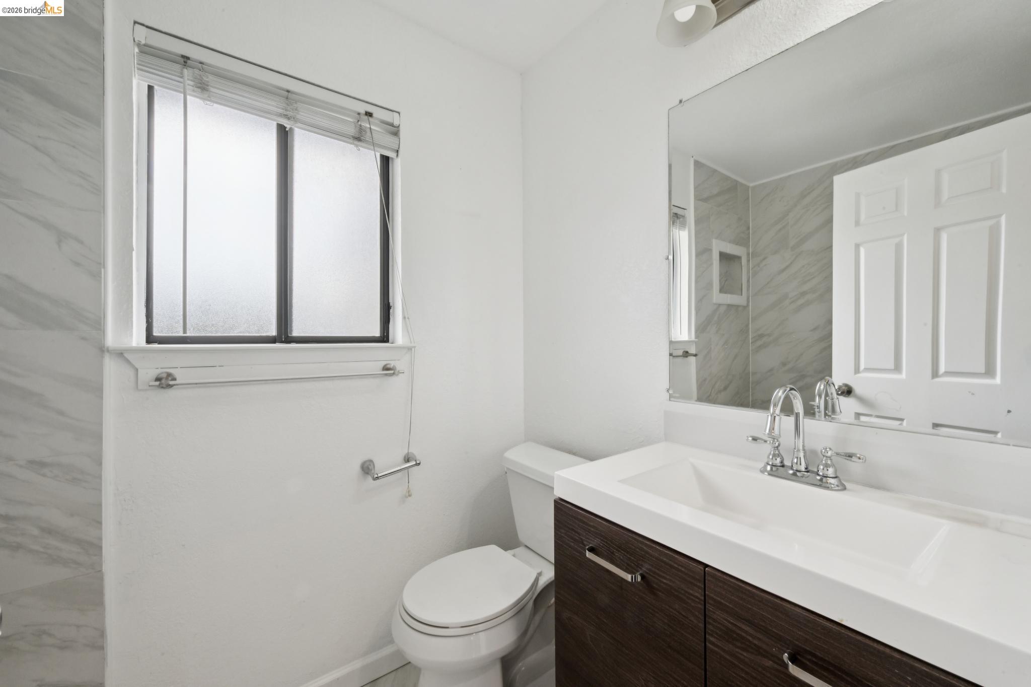 2600 Giant Road, Unit 35 San Pablo, CA 94806 - Photo 11 of 15 a bathroom with a sink a toilet and a mirror